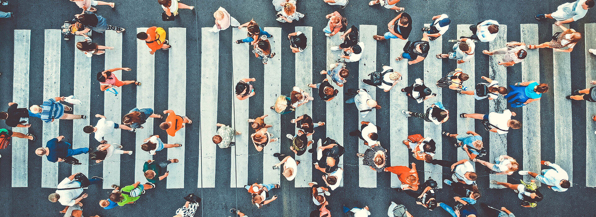 a photo from above of people walking across a street